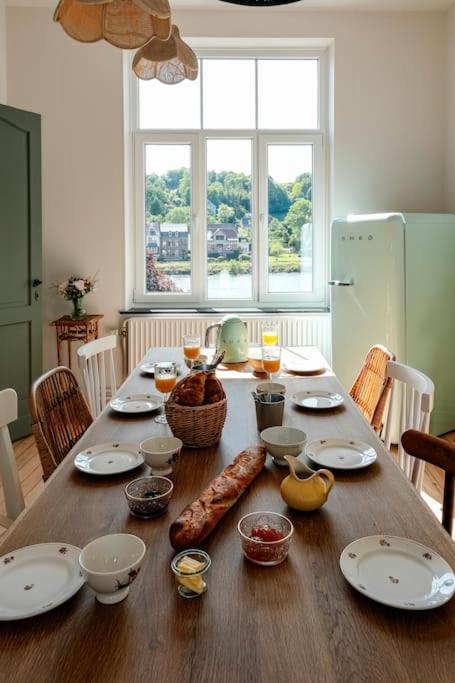 a wooden table with food on top of it at La Maison du Rivage in Dinant
