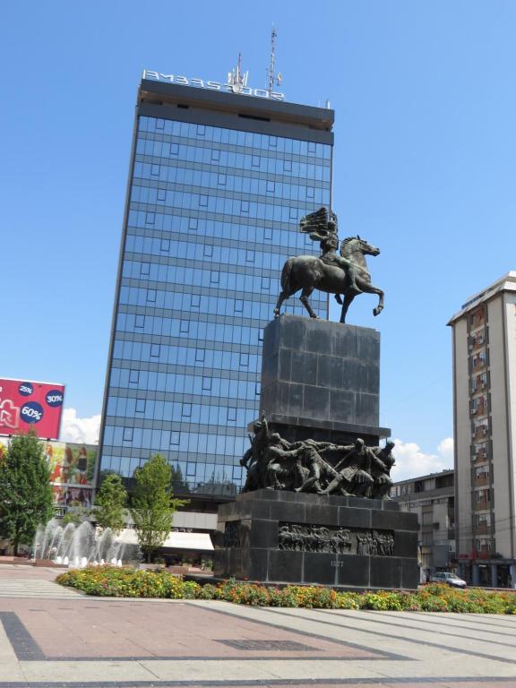 a statue of a horse in front of a building at Lux apartment 8, center, free parking in Niš