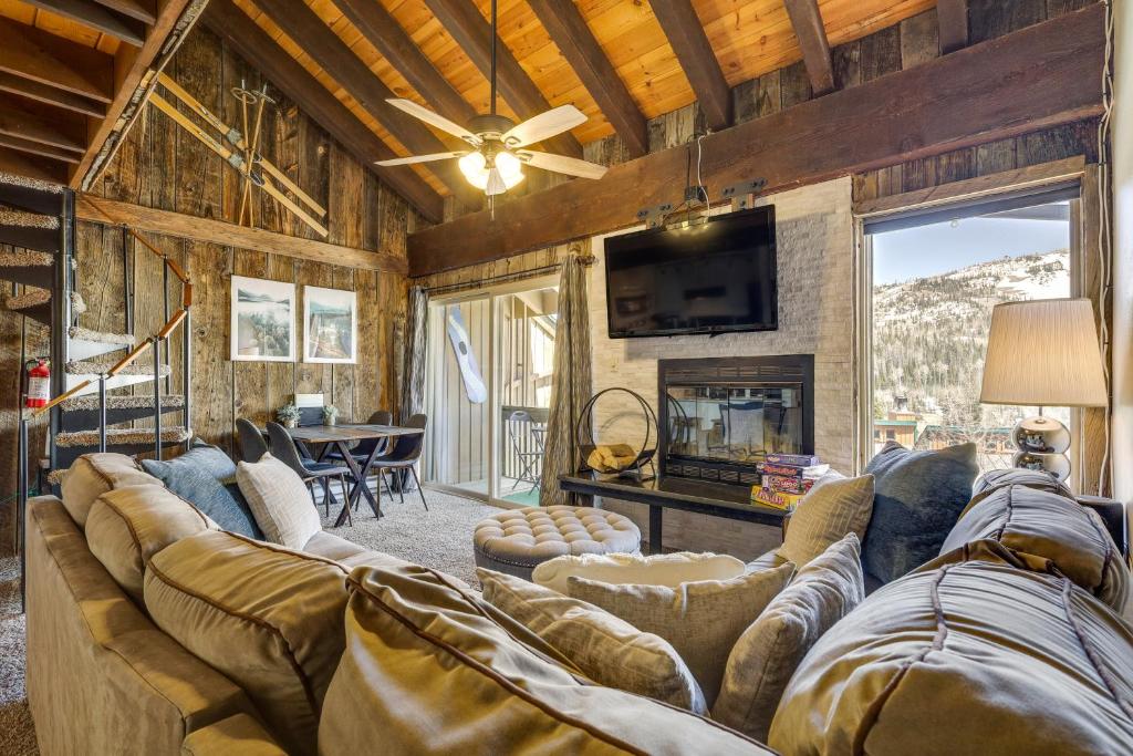 a living room with a large couch and a fireplace at Townhome with Mtn View - Walk to Brian Head Lifts! in Brian Head
