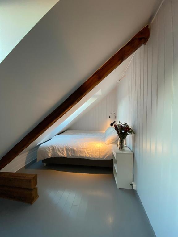 a bedroom with a bed in the attic at Storsand Gård in Trondheim