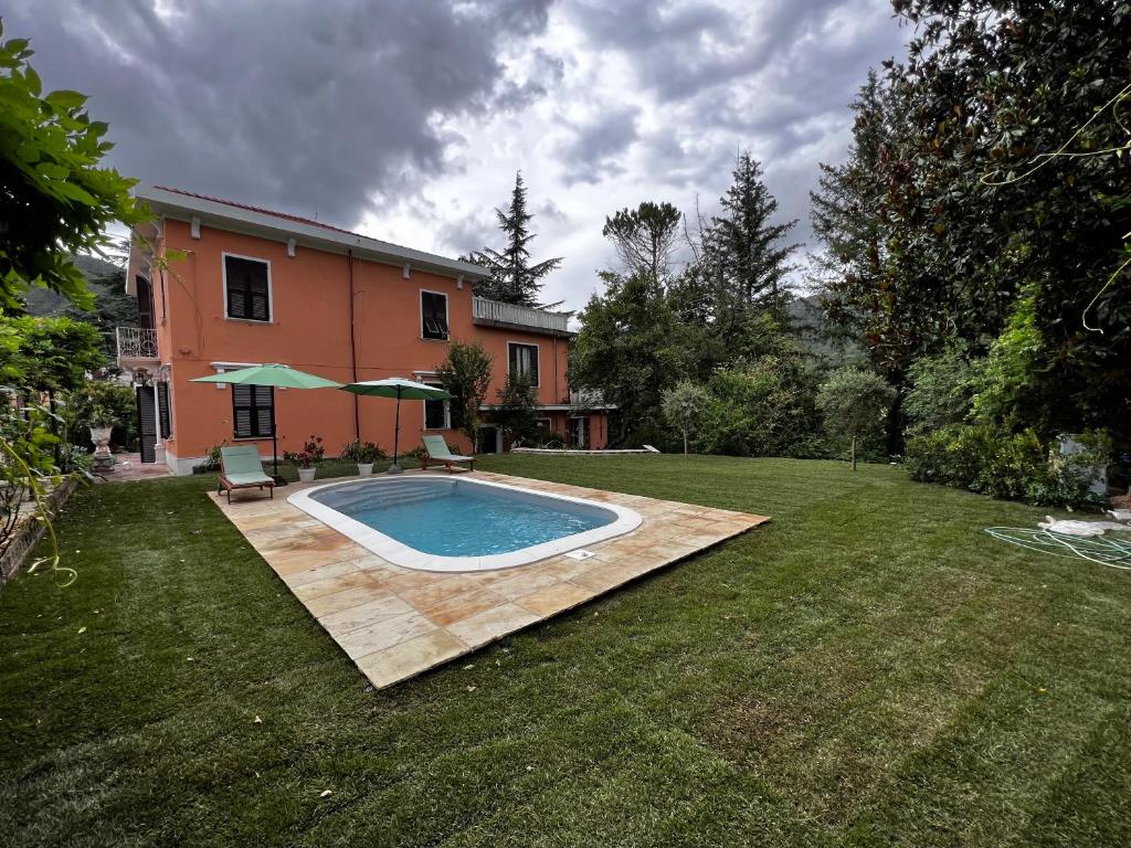 a swimming pool in the yard of a house at Villa Cinque Terre in Beverino