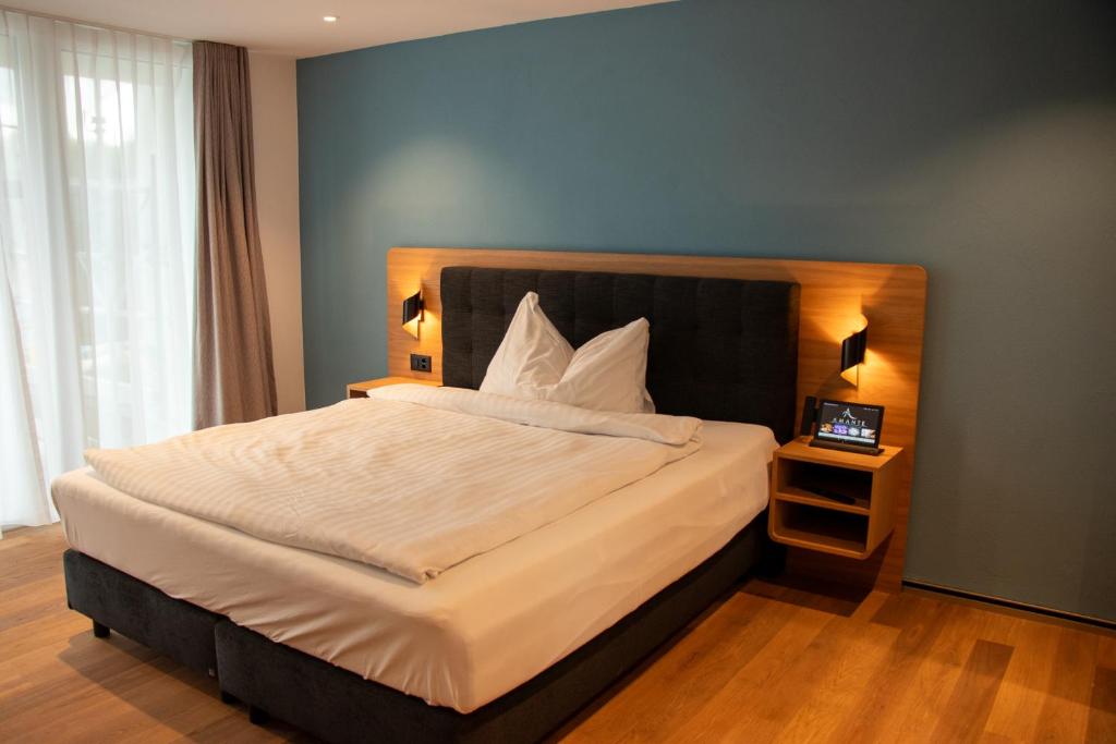 Postel nebo postele na pokoji v ubytování AMANTE Hotel