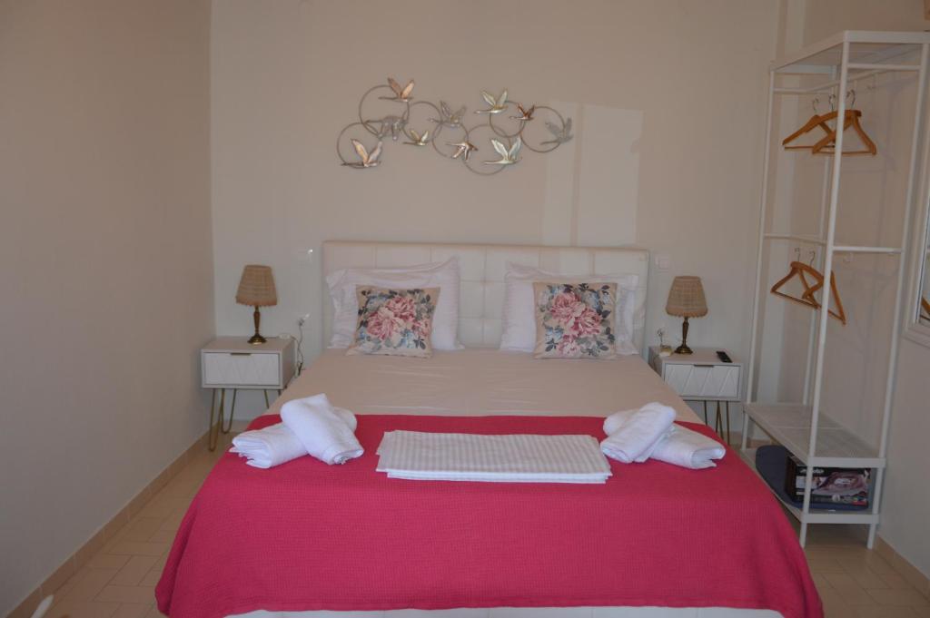 a bedroom with a large bed with towels on it at Elite Suites in Afitos