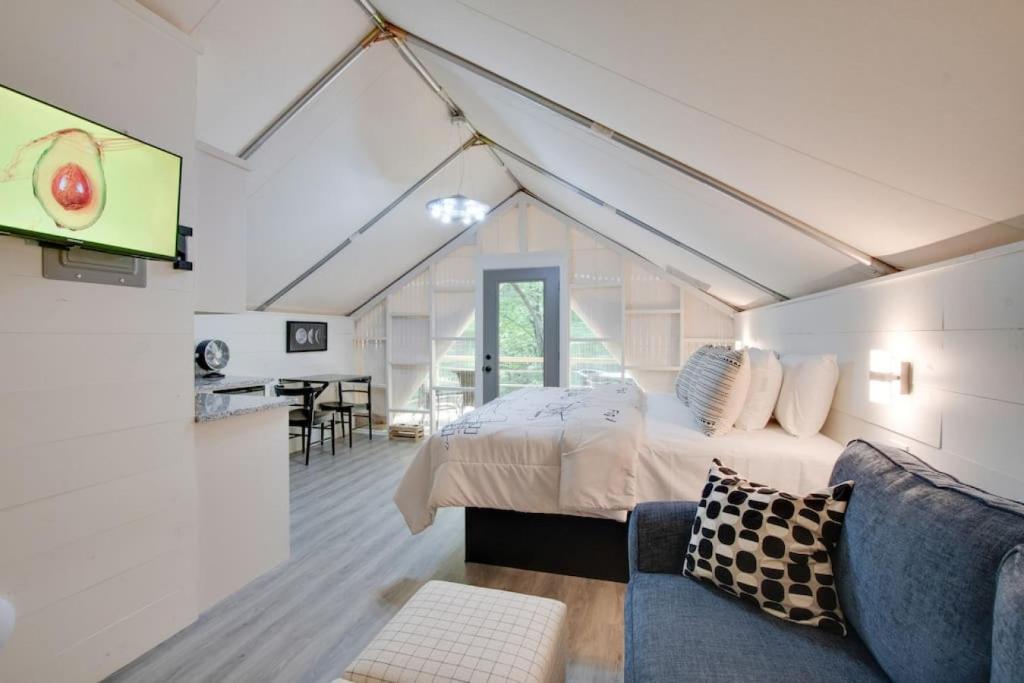 a bedroom with a bed and a tv in a room at 12 Launch Pad Luxury Glamping Tent Space Theme in Scottsboro