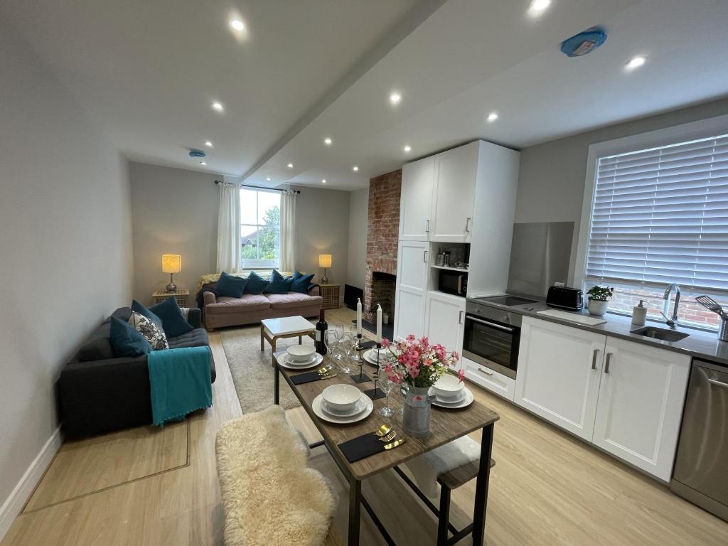 a kitchen and living room with a table and a couch at The Greig 1B in Wadhurst