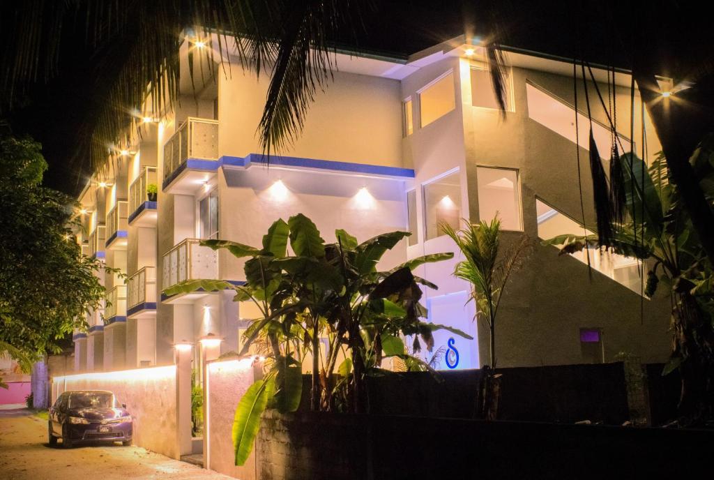a car parked in front of a building at night at Silver County Hotel, Fuvahmulah - Maldives in Fuvahmulah