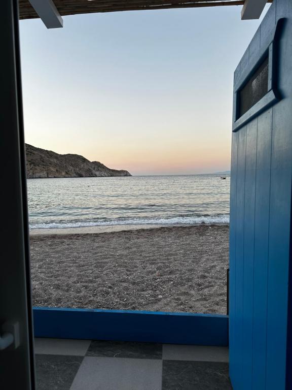 a view of the beach through a door at Aquamarine in Firopótamos