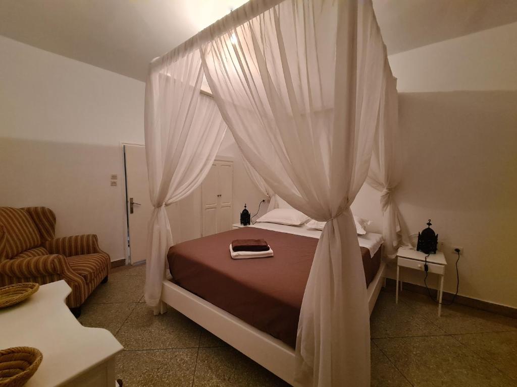 a bedroom with a bed with a canopy at La Maison des Vagues in Sidi Kaouki