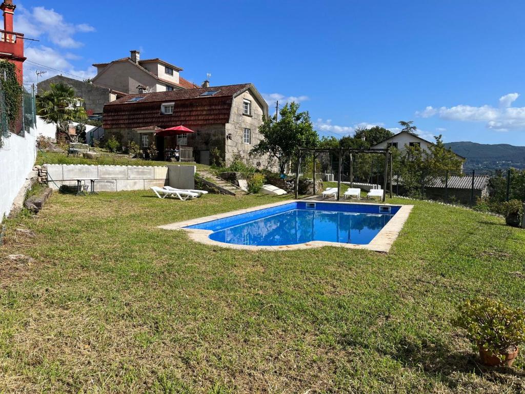 a swimming pool in the yard of a house at Villa Parra in Santa Cristina de Cobres
