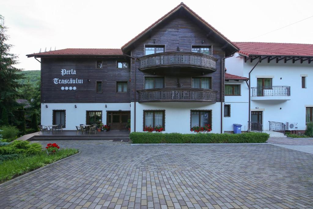 a large building with a balcony in front of it at Complex Turistic Perla Trascaului in Rimetea