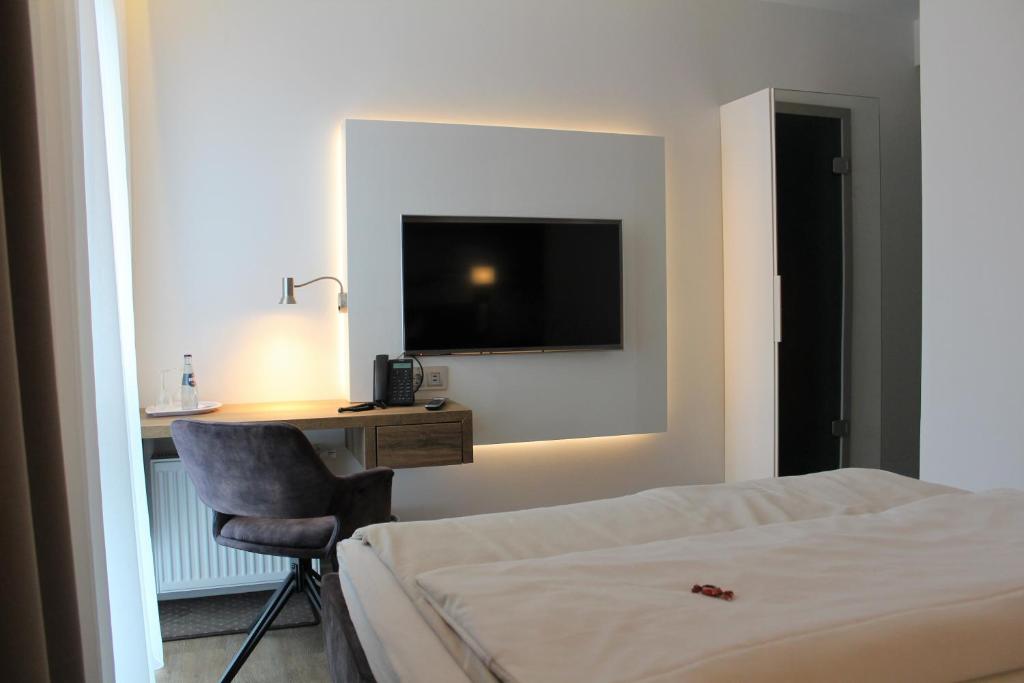 Postel nebo postele na pokoji v ubytování Hotel Ammerländer Hof