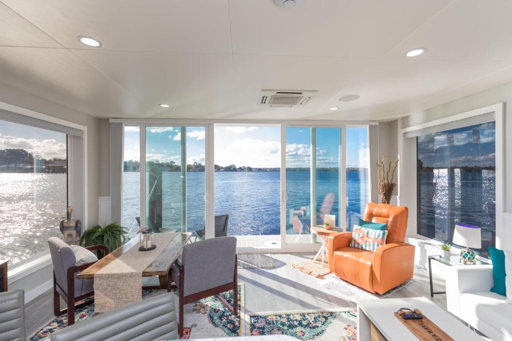 a living room with a view of the water at New Floating Luxury: Unique Houseboat Retreat in Fleming Island