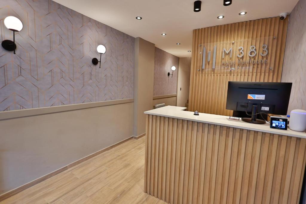 an office with a reception desk with a computer on it at M383 Hotel Bariloche in San Carlos de Bariloche