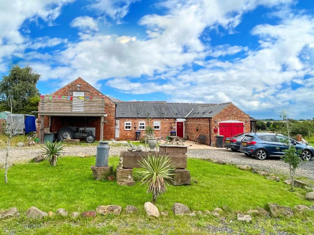 a brick house with a car parked in front of it at Starshinezzz - Large Farmhouse County Durham in Trimdon Grange