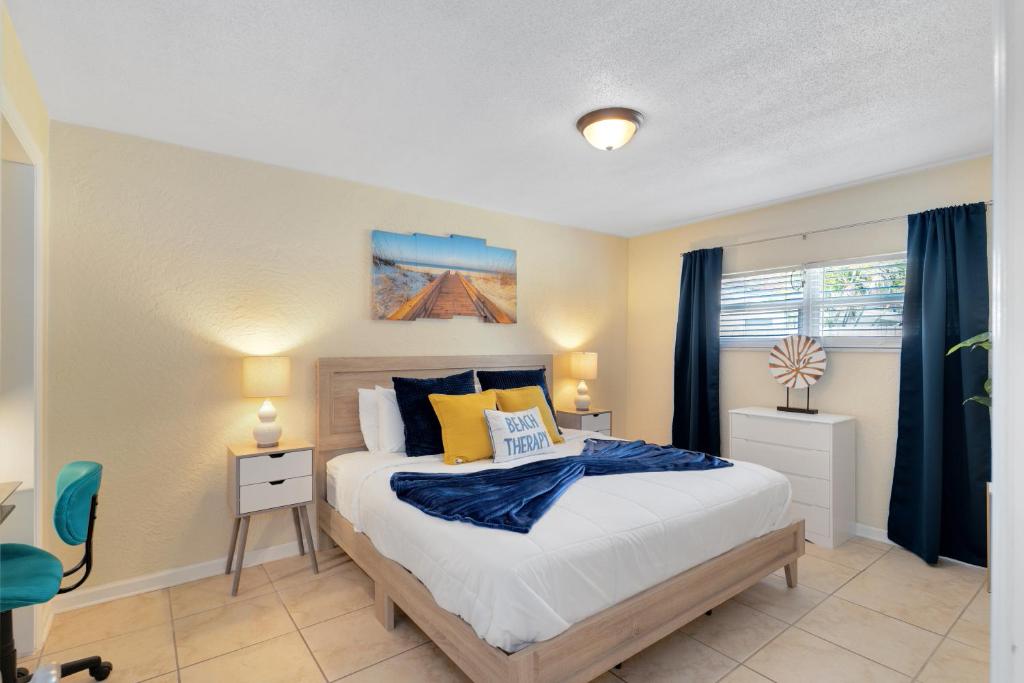 a bedroom with a bed with blue and yellow pillows at Ocean 19 - Tideside in Indian Harbour Beach