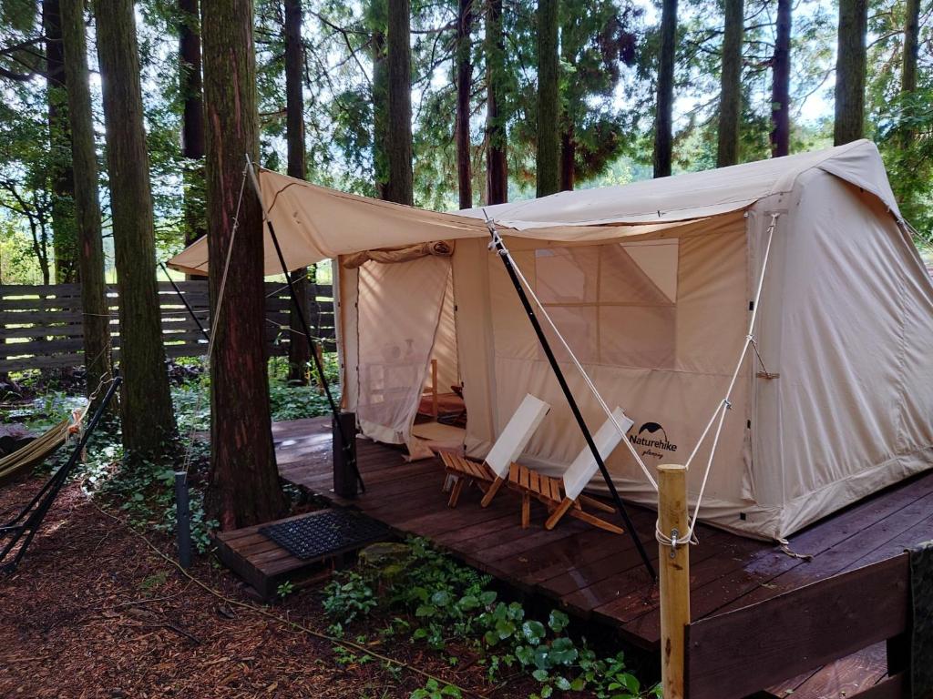 a tent on a wooden deck in the woods at Minamiaso STAYHAPPY - Vacation STAY 28491v in Shimoda