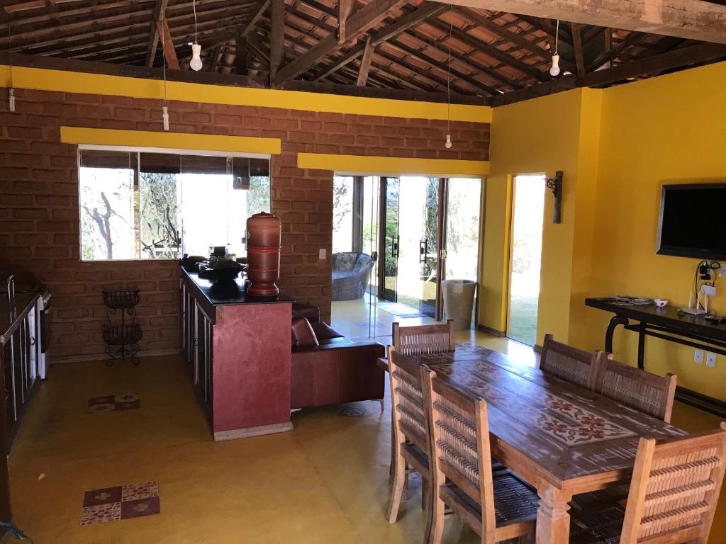 Casa Luz في ميلهو فيردا: غرفة طعام مع طاولة وكراسي خشبية