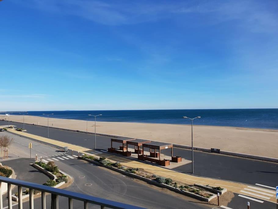 vistas a la playa y a una carretera con bancos en Week end romantique FACE A LA MER, en Narbonne-Plage