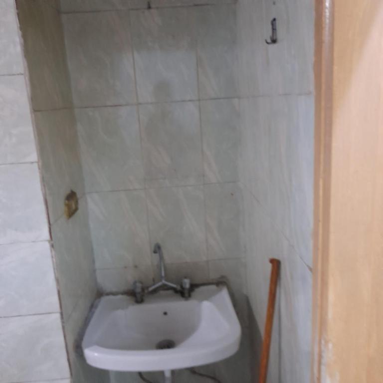 a bathroom with a white sink in a room at شقه للايجار جاهزه بالكامل in Cairo