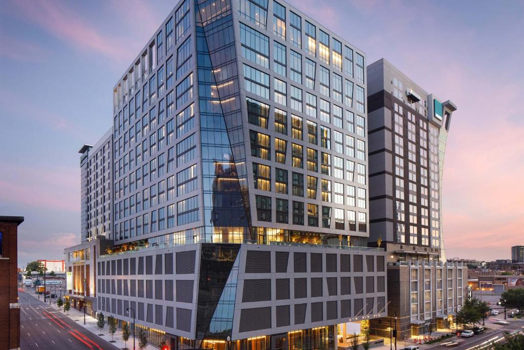 a tall glass building on a city street at The Joseph, a Luxury Collection Hotel, Nashville in Nashville