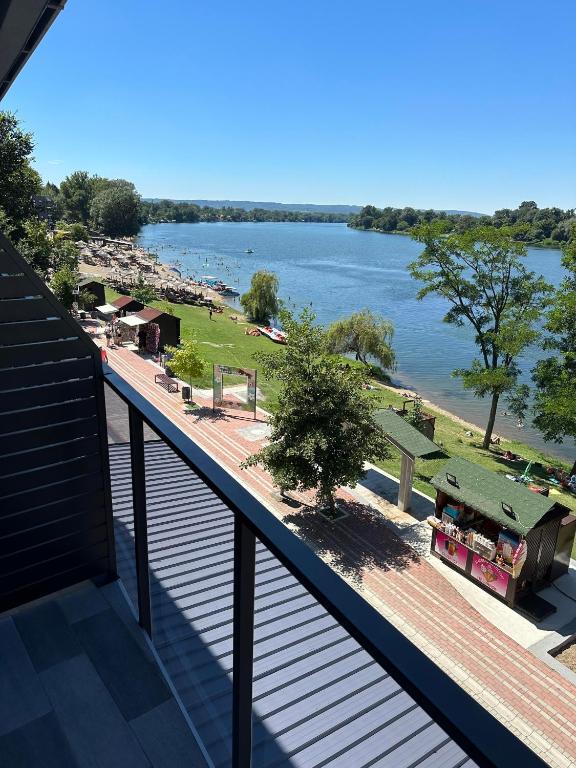 a balcony with a view of the water and a beach at Romantika 1 in Ostrovo