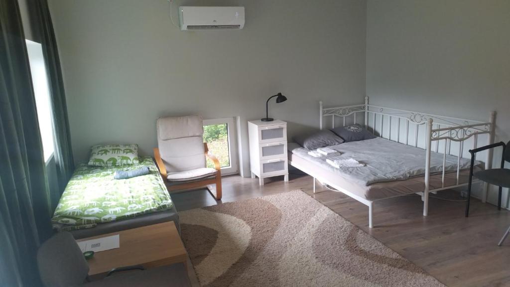 a bedroom with two bunk beds and a table at Guesthouse near Tallinn in Lehmja