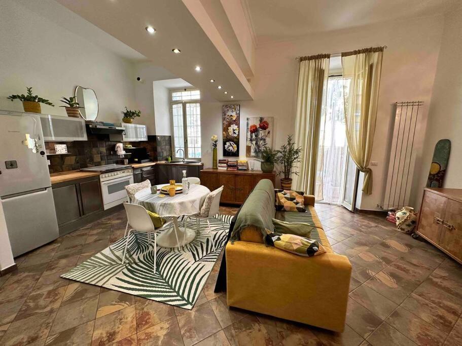 a large living room with a couch and a kitchen at Casa di Lo in Ciampino