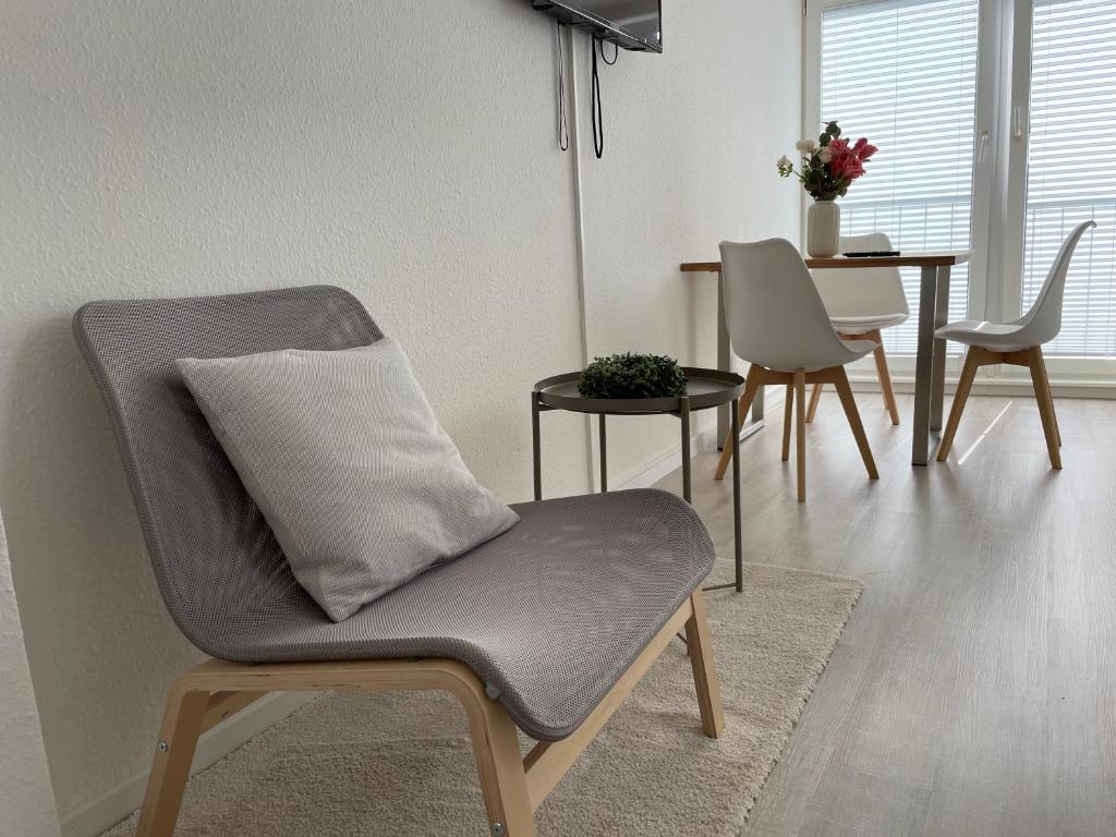 a living room with a chair and a table at Schlafkonzept Hannover in Hannover