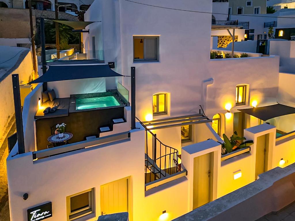 an aerial view of a building with a swimming pool at Tiara Suites Santorini in Fira