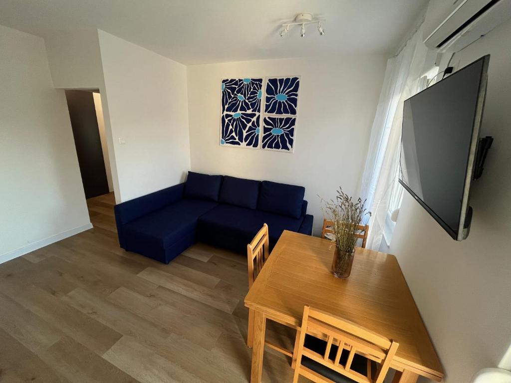 a living room with a blue couch and a table at Apartment TIM in Split