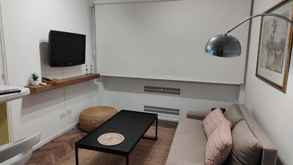 a living room with a couch and a table at Luminoso Estudio en Palermo! II in Buenos Aires