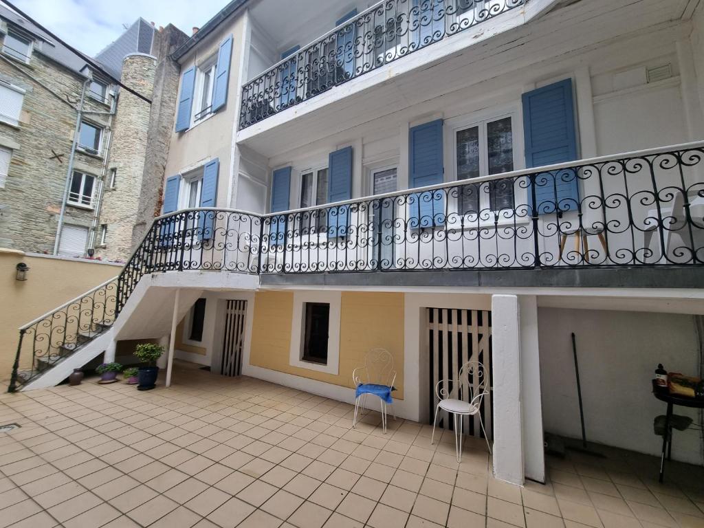 a balcony of a house with a staircase at Duplex F3 hypercentre Cherbourg près du port in Cherbourg en Cotentin