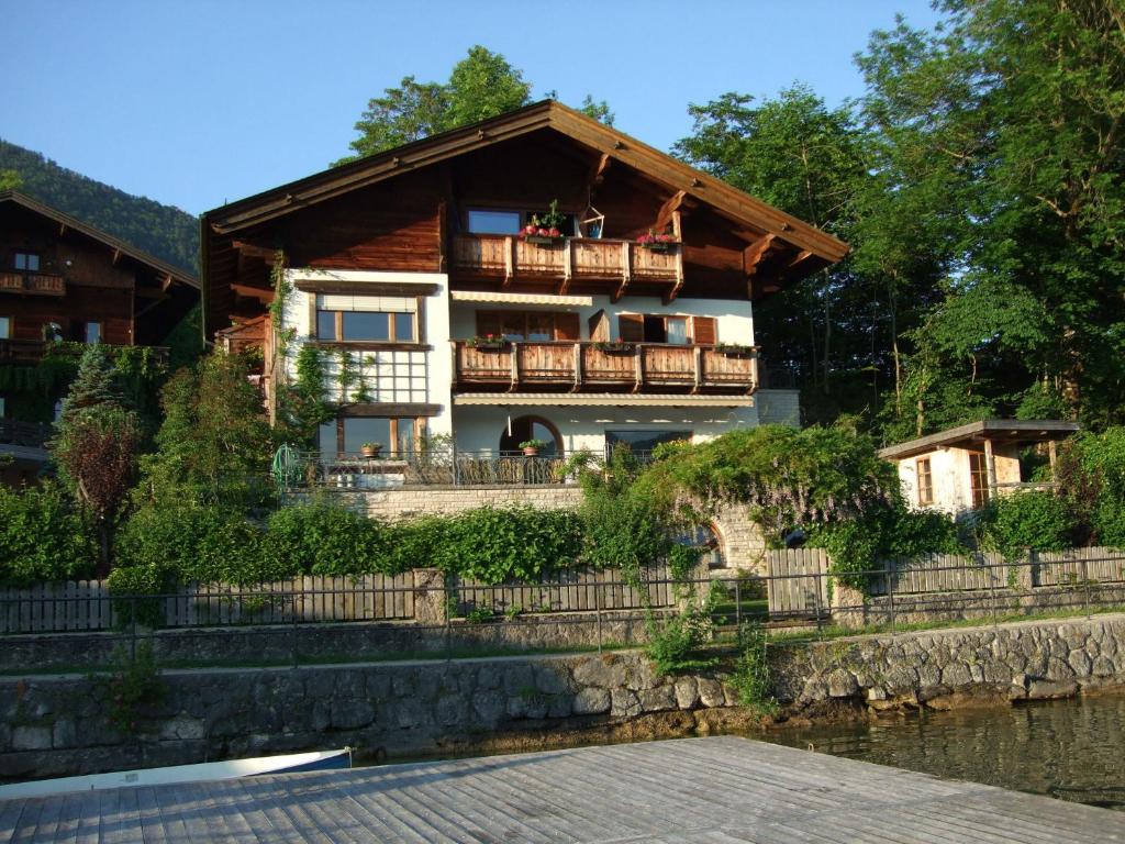 a house with a balcony and a river at Apartment Schilcher in St. Wolfgang