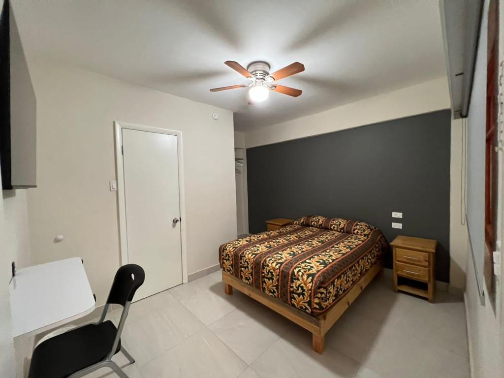 a bedroom with a bed and a ceiling fan at HOTEL VILLAGRAN in Tijuana