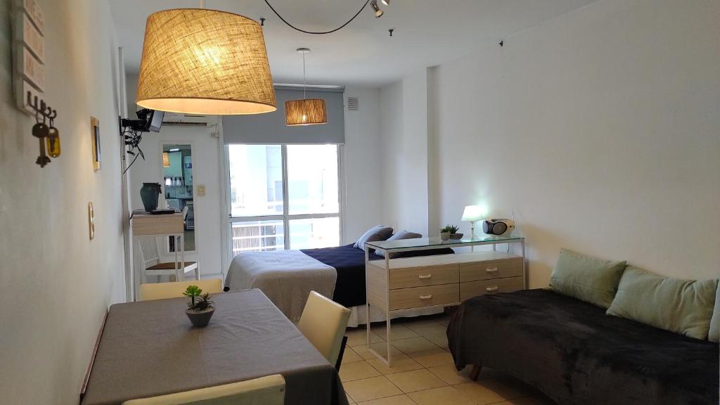 a small living room with a bed and a couch at Moreno1300/9 in Rosario
