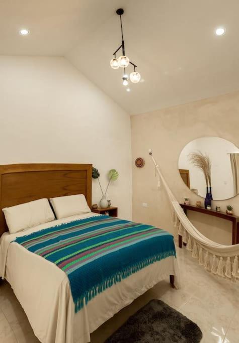 a bedroom with a bed and a large mirror at Departamento amplio, privado y completo in Valladolid
