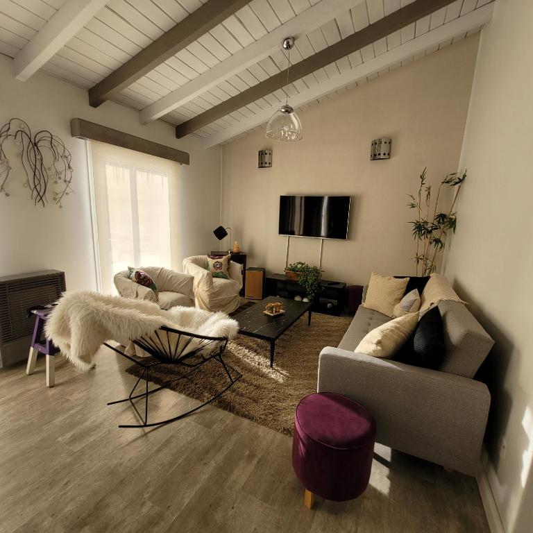 a living room with two couches and a tv at TADASANA HOUSE in Ushuaia