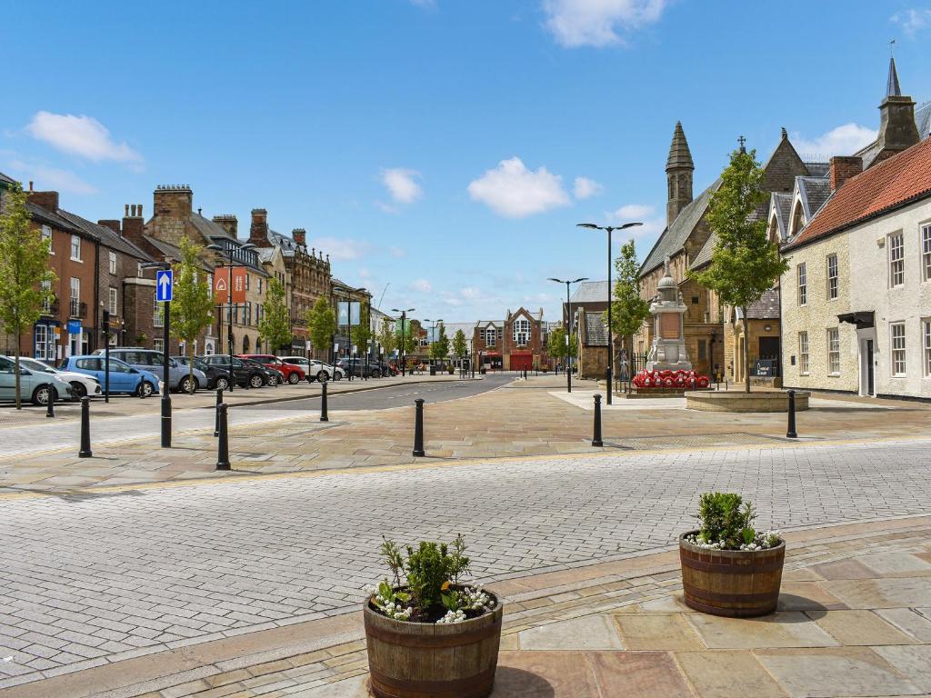an empty street in a town with cars parked at Number Three - Uk44866 in Bishop Auckland