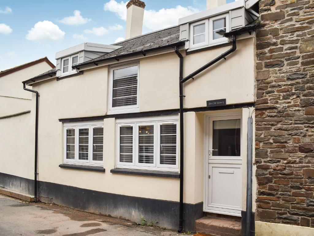 a white house with a white door and windows at The Old Buttery in Chulmleigh