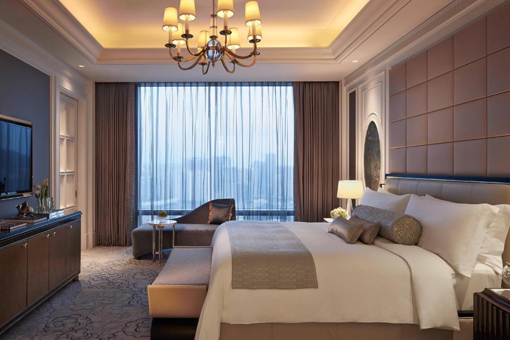 a bedroom with a large bed and a large window at The Ritz-Carlton, Macau in Macau