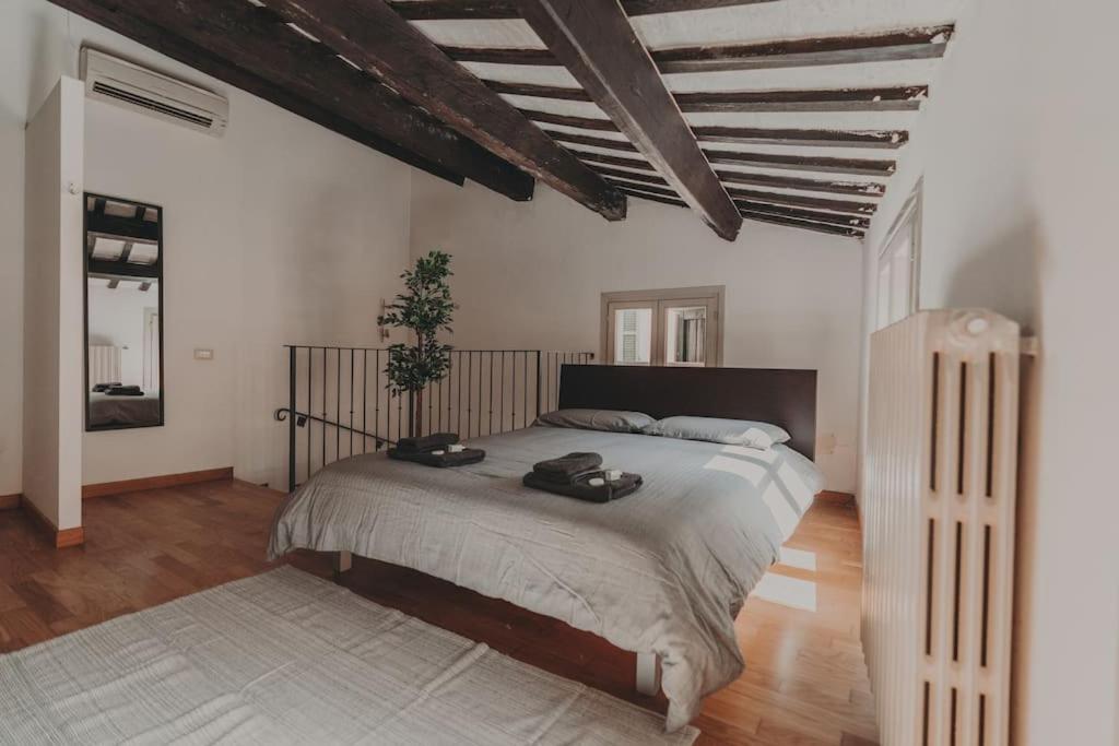 a bedroom with a large bed in a room at [Centro] Casa con parcheggio in Ravenna