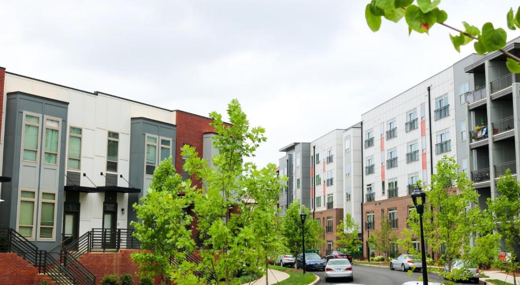 a row of apartment buildings on a city street at Modern 1BD Studio Apt in Plaza Midwood with Community Pool in Charlotte