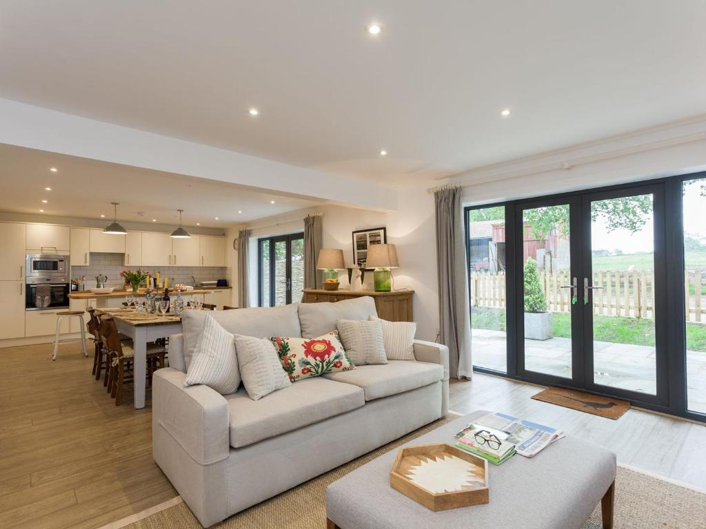 a living room with a couch and a table at The Stables in Cheriton