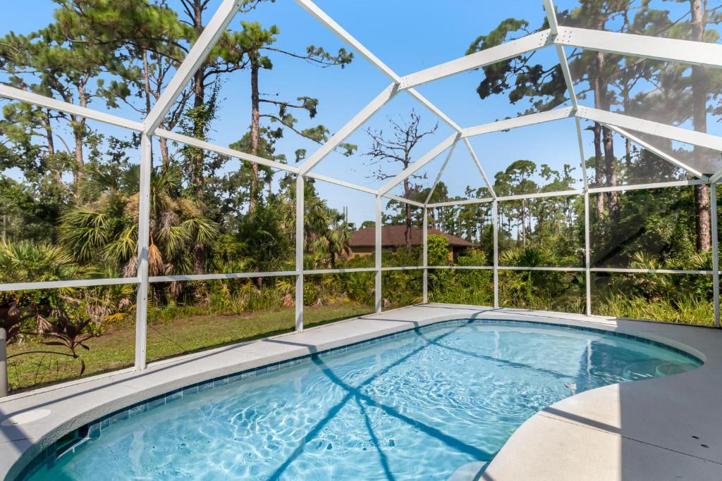 a swimming pool in a glass house with a swimming poolvisor at Port Charlotte Chateau in North Port