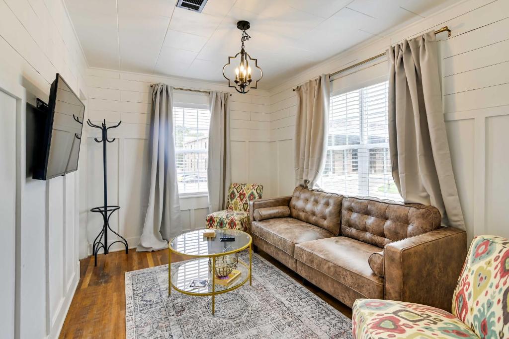 a living room with a couch and a table at Cozy Starkville Apartment Walk to Main Street! in Starkville