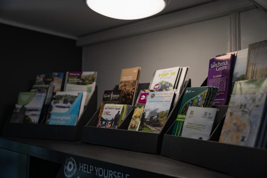 a row of books sitting on top of a shelf at The Briers Country House in Newcastle