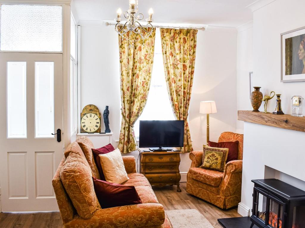 a living room with two chairs and a television at The Nook in Bishop Auckland