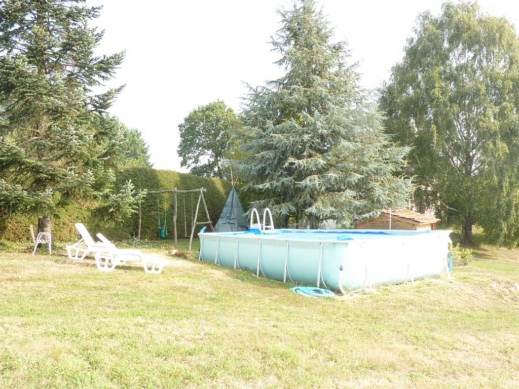 a swimming pool in the middle of a field at Gîte Sansac-Veinazès, 3 pièces, 4 personnes - FR-1-742-114 