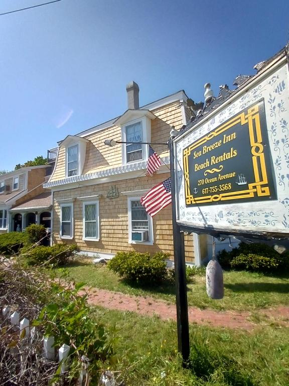 a sign in front of a house at Sea Breeze Inn beach rentals in Barnstable
