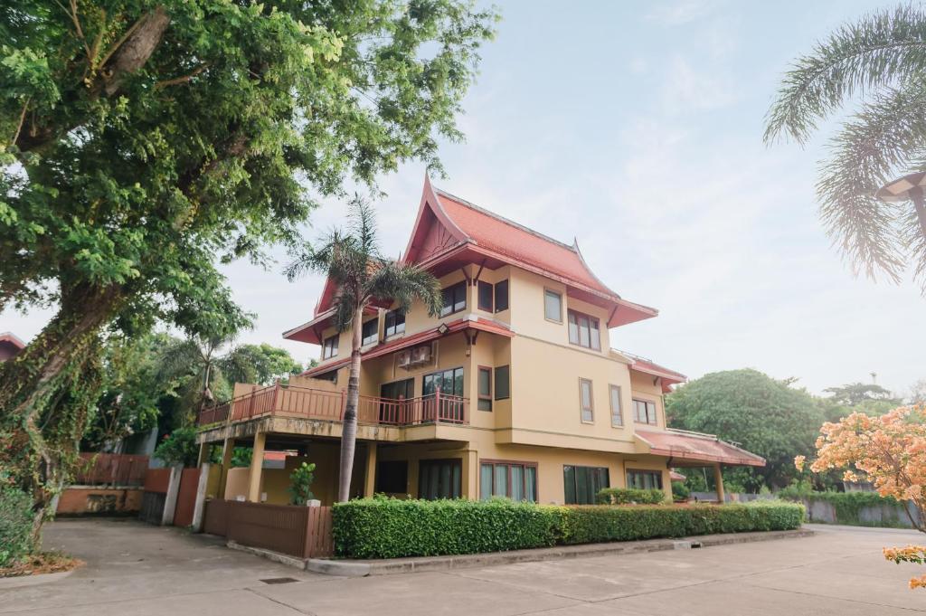 a large yellow building with a red roof at Ruen Thai Siray Green in Phuket